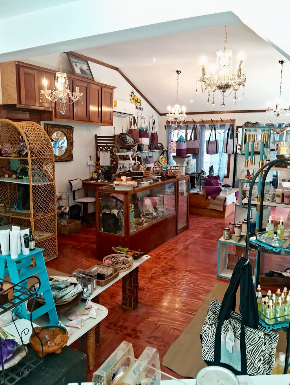 A boutique interior featuring decorative items, handbags, and various products displayed on wooden shelves.